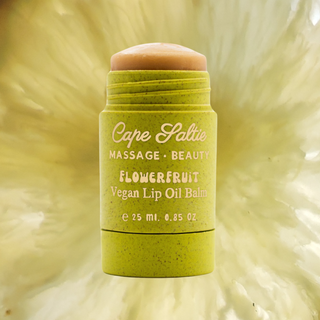 Cape Saltie's Flowerfruit Vegan Lip Oil Balm is the ultimate, best lip balm, lip gloss hybrid designed for bouncy hydration, glossy lips, and long-lasting moisture. This jumbo, supersized lip balm glides on like butter, offering a natural, sheer almost-pink tint that leaves your lips soft, supple, and tack-free. Infused with organic flavoring oils and a powerful blend of nourishing ingredients like grapeseed oil, organic coconut oil, sunflower seed oil, calendula flower, and mango seed butter, this vegan, g