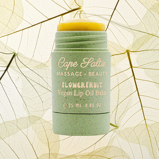 Cape Saltie's Flowerfruit Vegan Lip Oil Balm is the ultimate, best lip balm, lip gloss hybrid designed for bouncy hydration, glossy lips, and long-lasting moisture. This jumbo, supersized lip balm glides on like butter, offering a natural, sheer almost-pink tint that leaves your lips soft, supple, and tack-free. Infused with organic flavoring oils and a powerful blend of nourishing ingredients like grapeseed oil, organic coconut oil, sunflower seed oil, calendula flower, and mango seed butter, this vegan, g